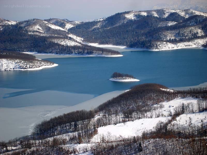 Snowy lake with island