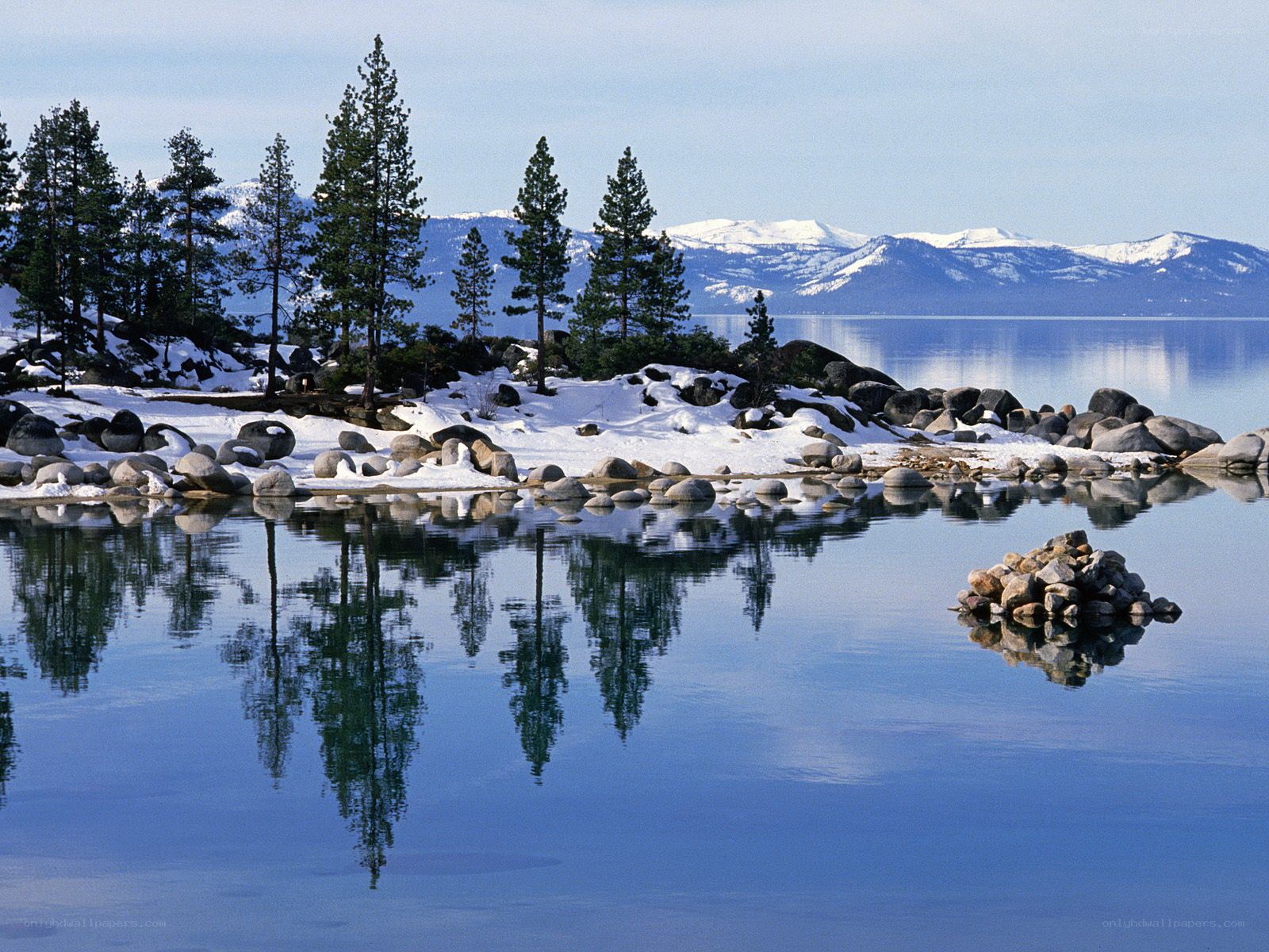 Snowy lake with mountain reflection