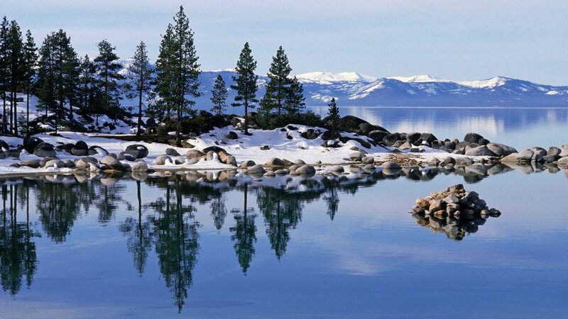 Snowy lake with mountain reflections