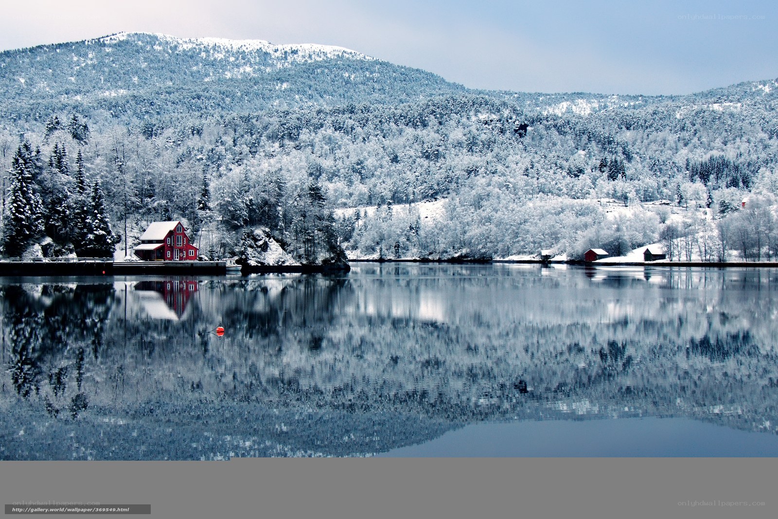 Snowy lake with red house