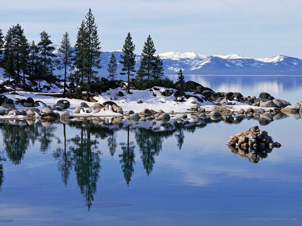Snowy lake with tree reflections