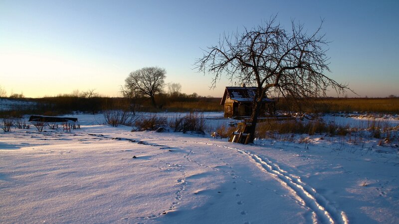Snowy landscape with cabin