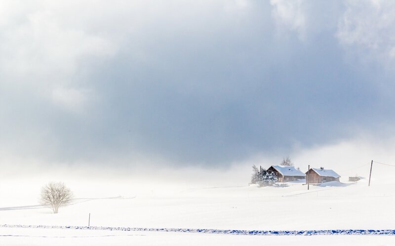 Snowy landscape with cabins