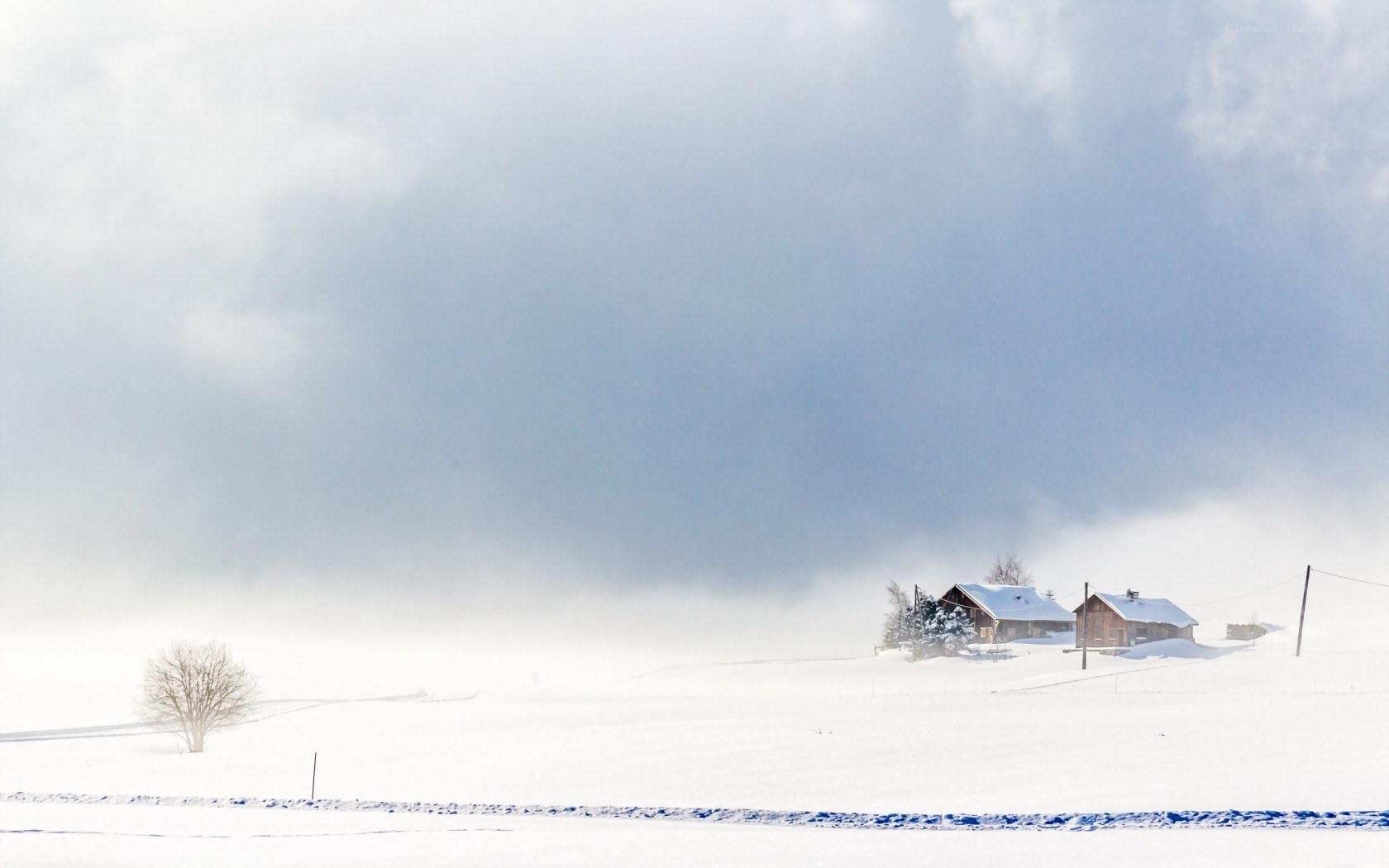 Snowy landscape with cabins