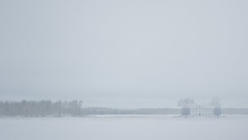 Snowy landscape with distant house