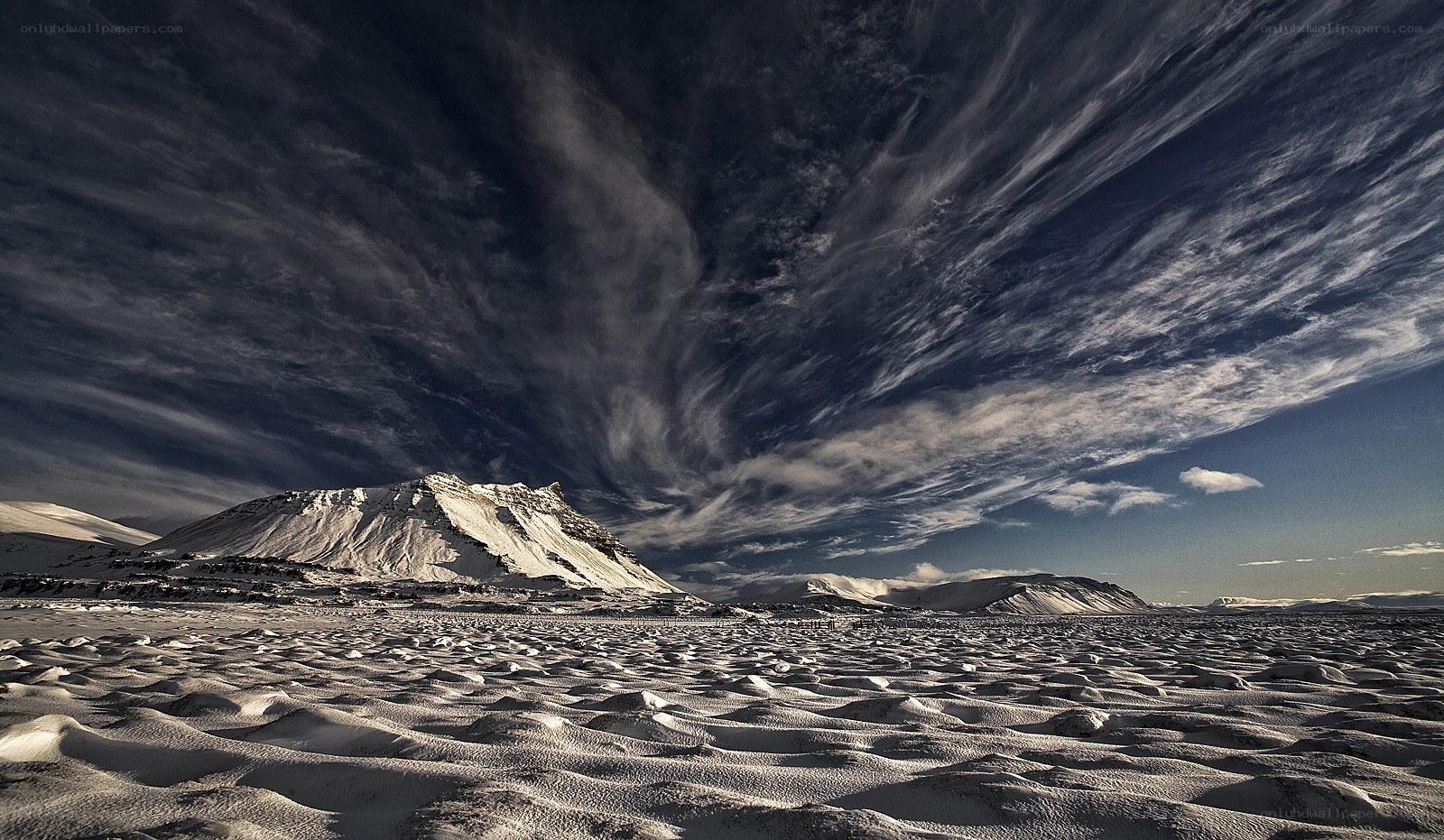 Snowy landscape with dramatic sky
