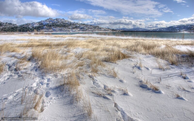 Snowy landscape with lake and hills