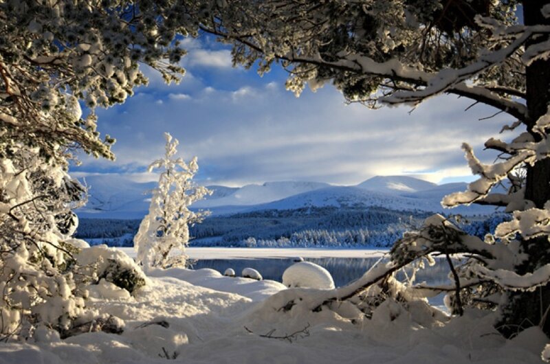 Snowy landscape with lake and mountains