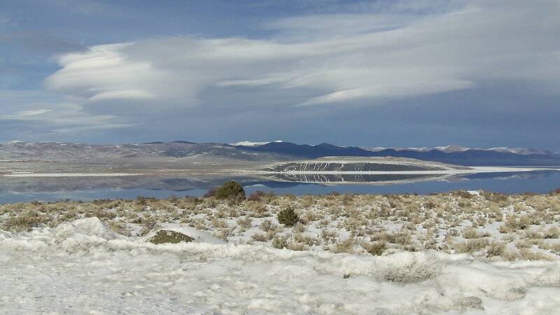 Snowy landscape with lake and mountains