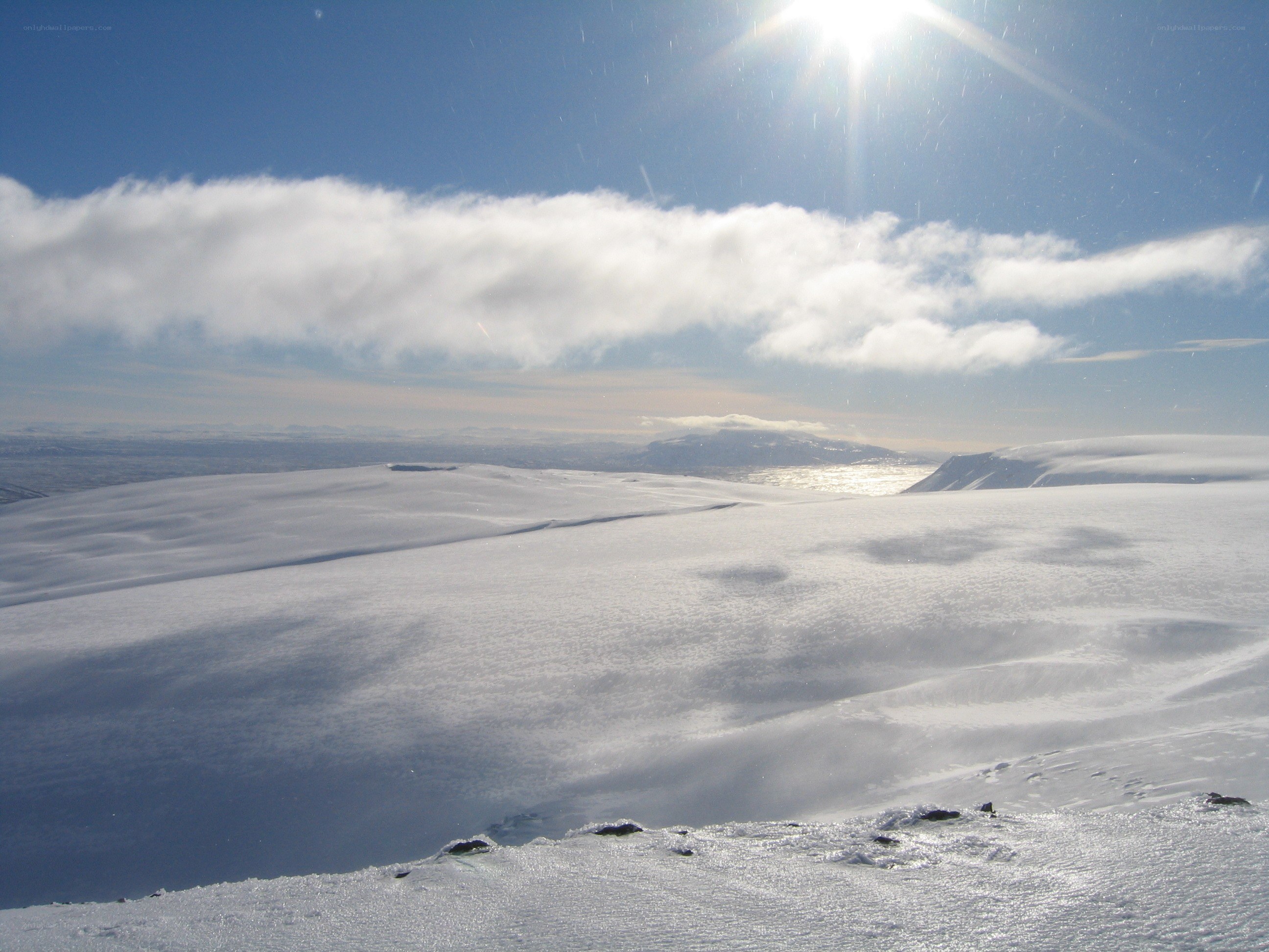 Snowy landscape with sun