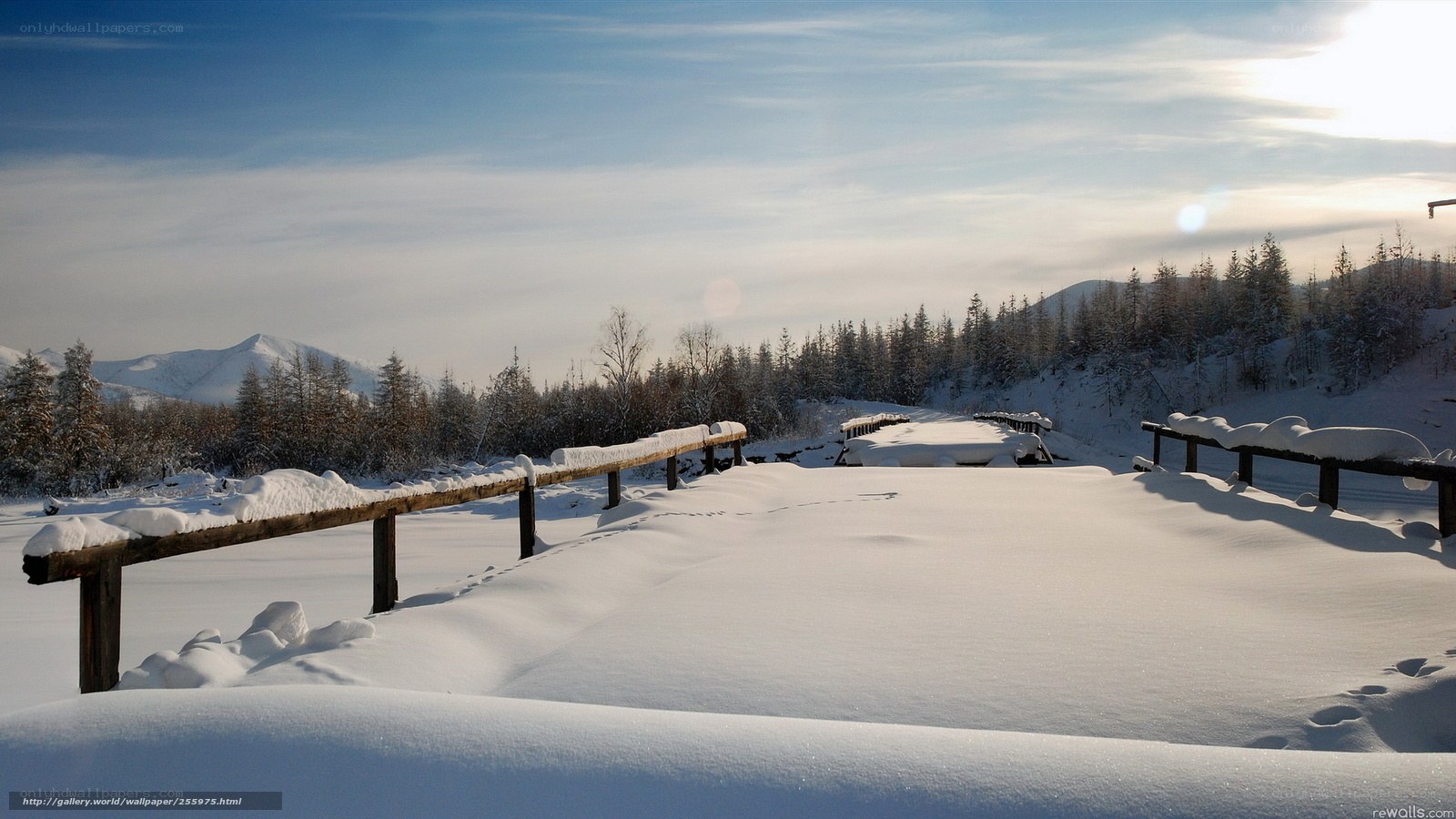 Snowy landscape with wooden fence