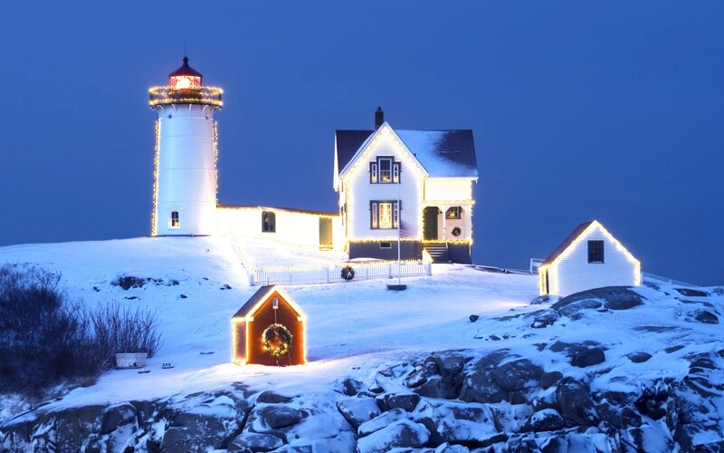 Snowy lighthouse at night