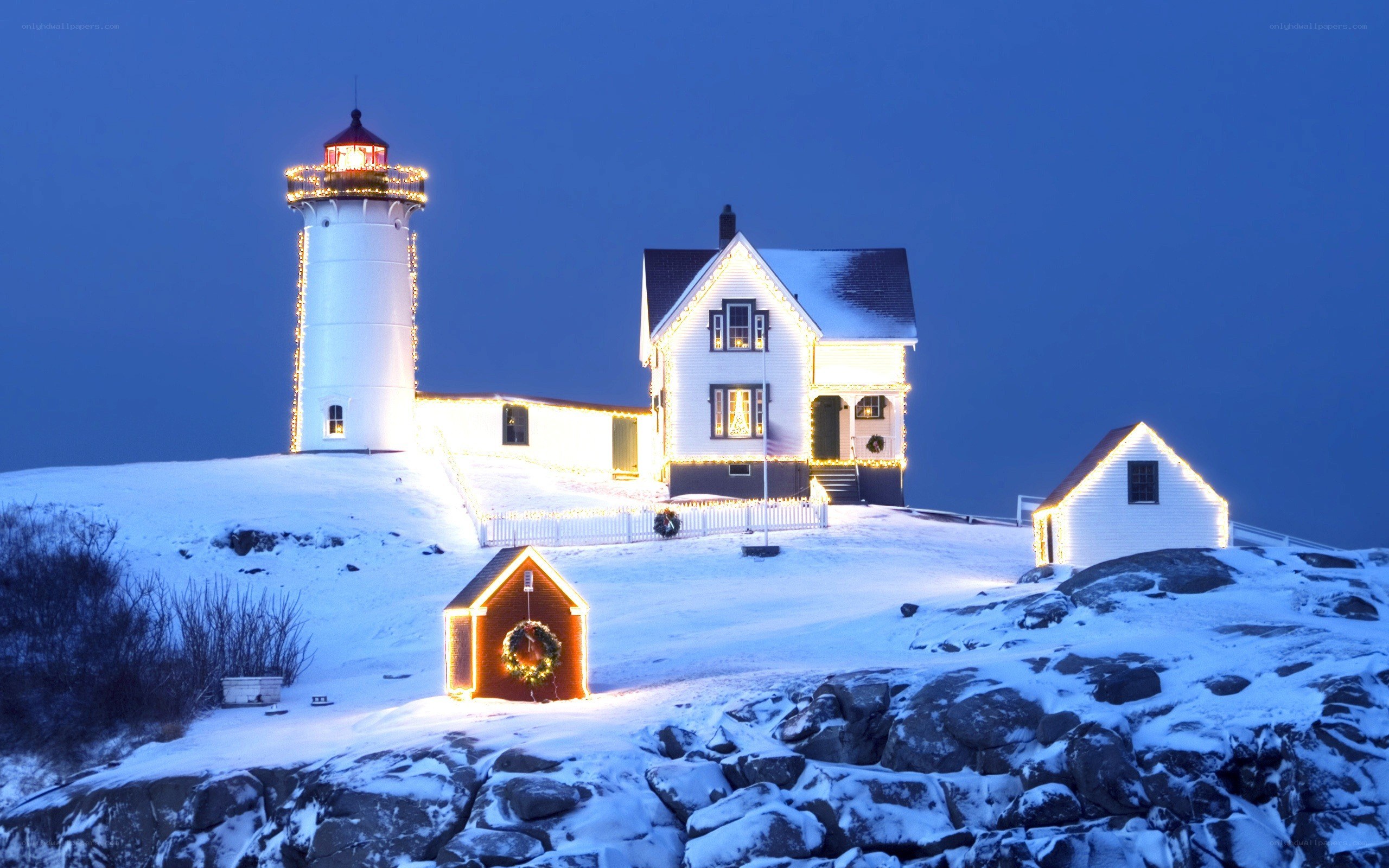 Snowy lighthouse at night