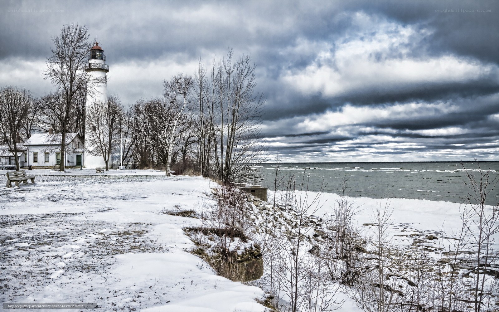 Snowy lighthouse by the lake