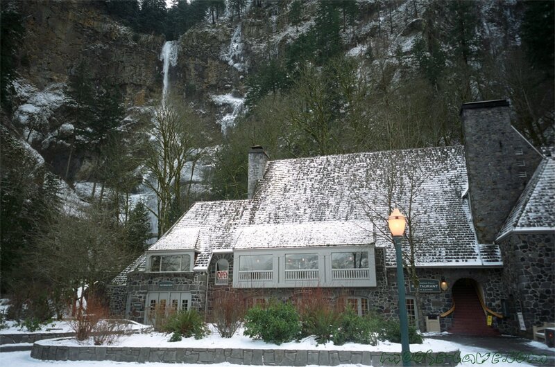 Snowy lodge with waterfall backdrop