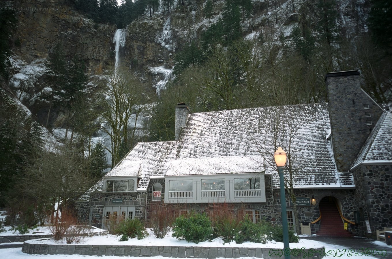 Snowy lodge with waterfall backdrop