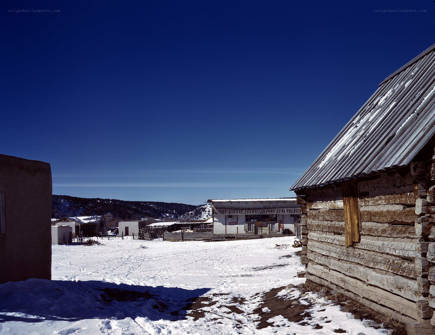 Snowy log cabin village
