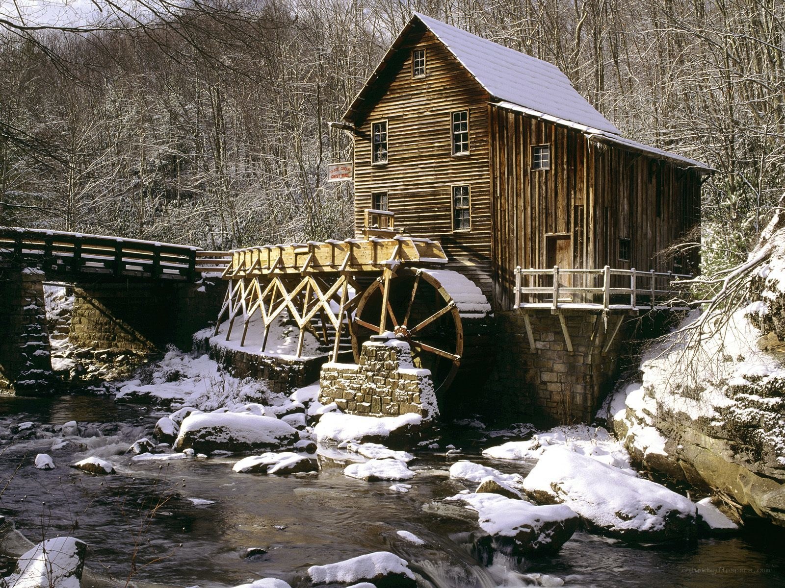 Snowy mill by a river