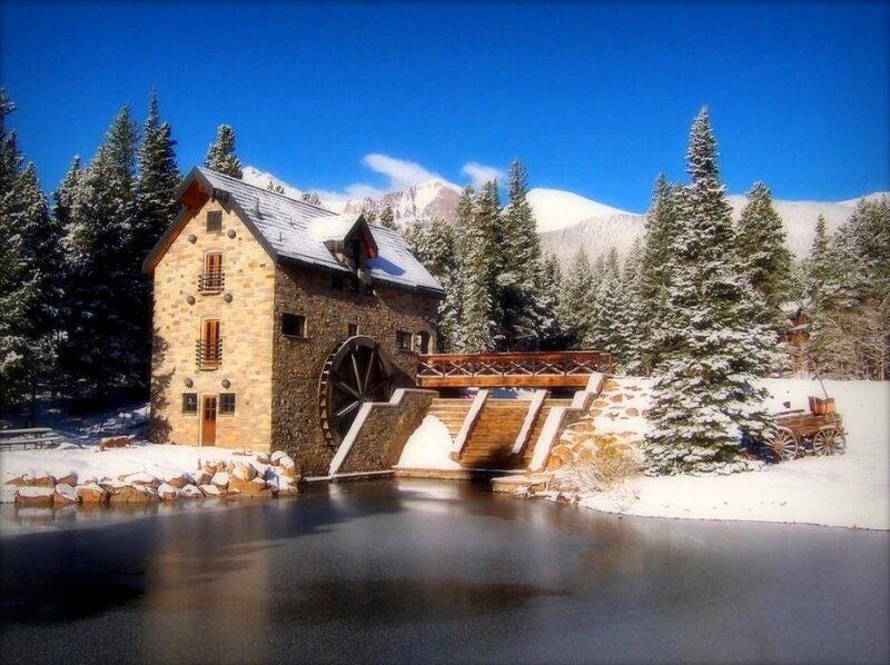 Snowy mill by a river