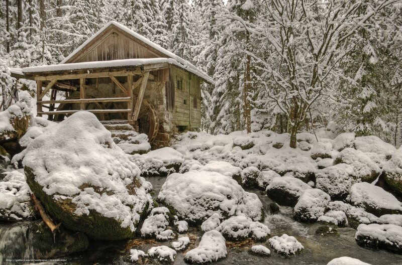 Snowy mill in winter forest