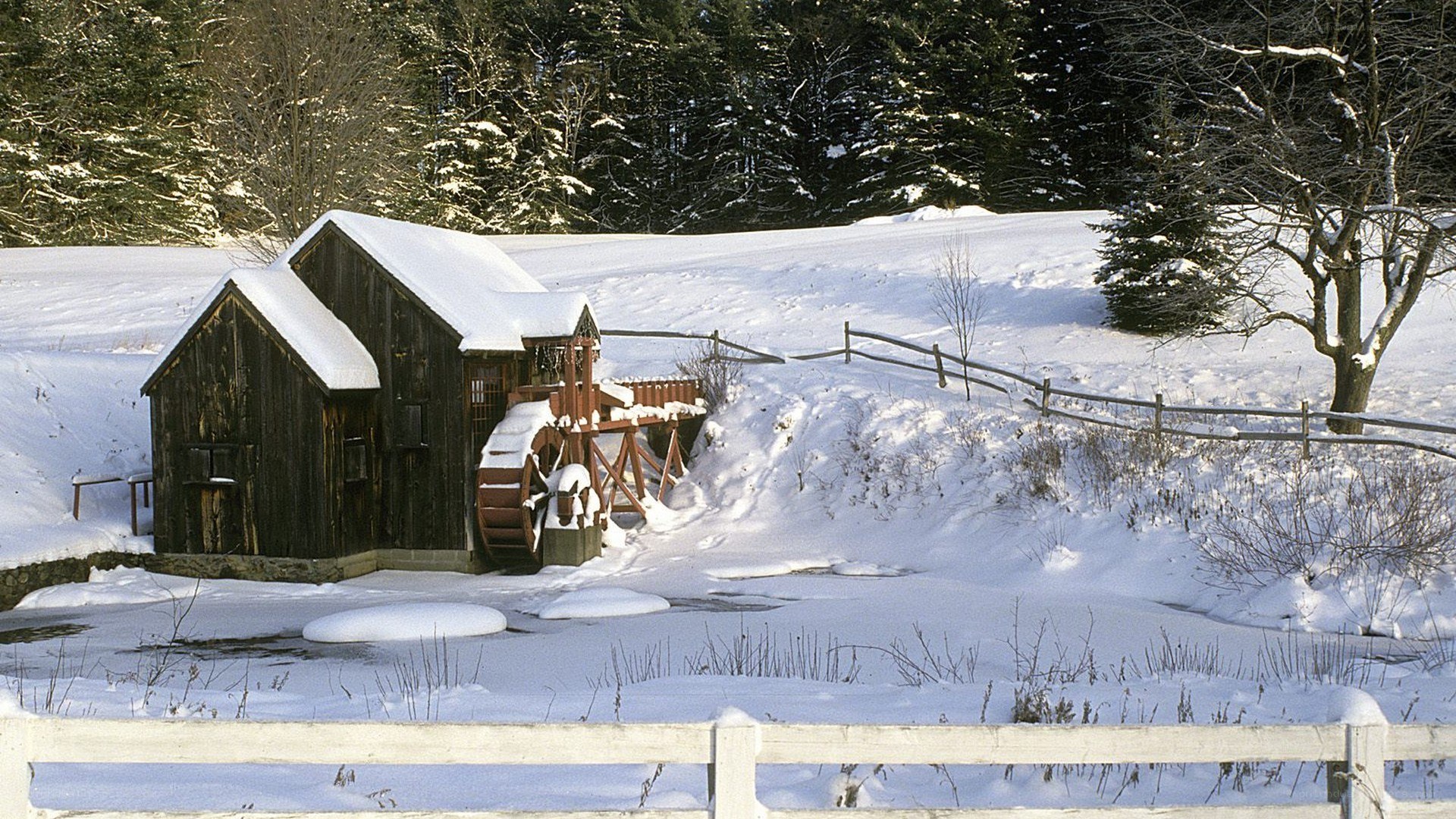 Snowy mill in winter landscape