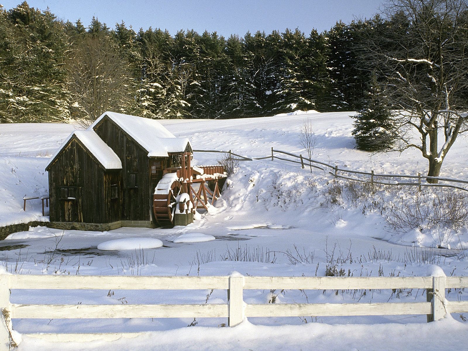 Snowy mill in winter landscape
