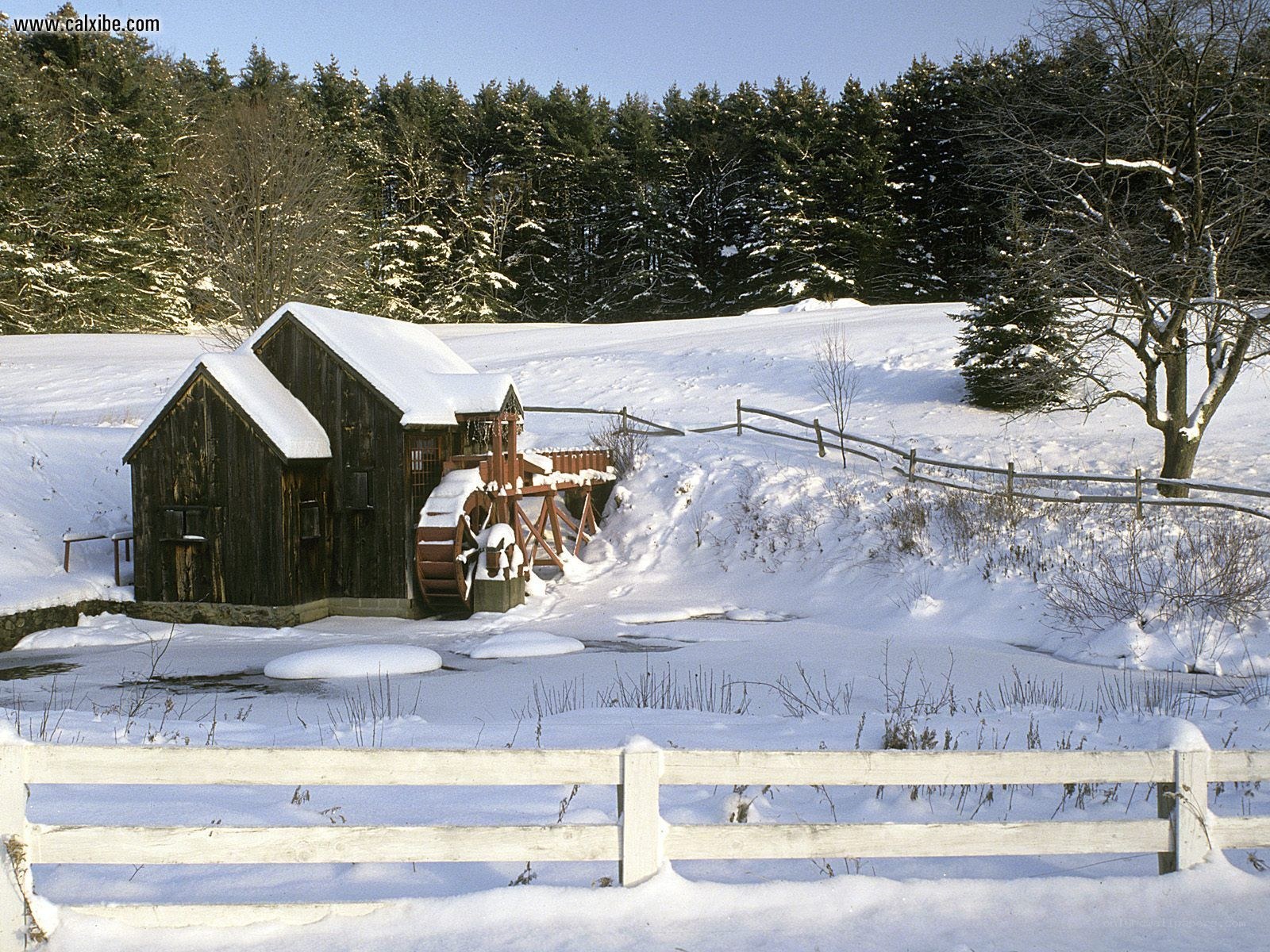 Snowy mill in winter landscape