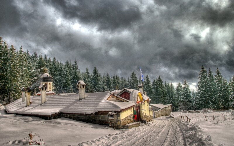 Snowy monastery in forest