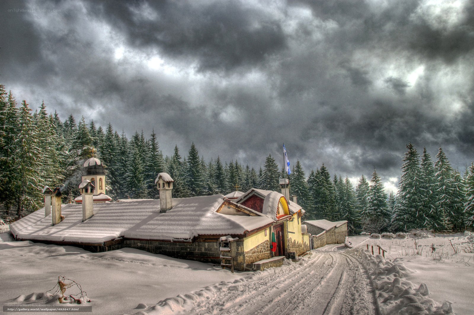 Snowy monastery under stormy sky
