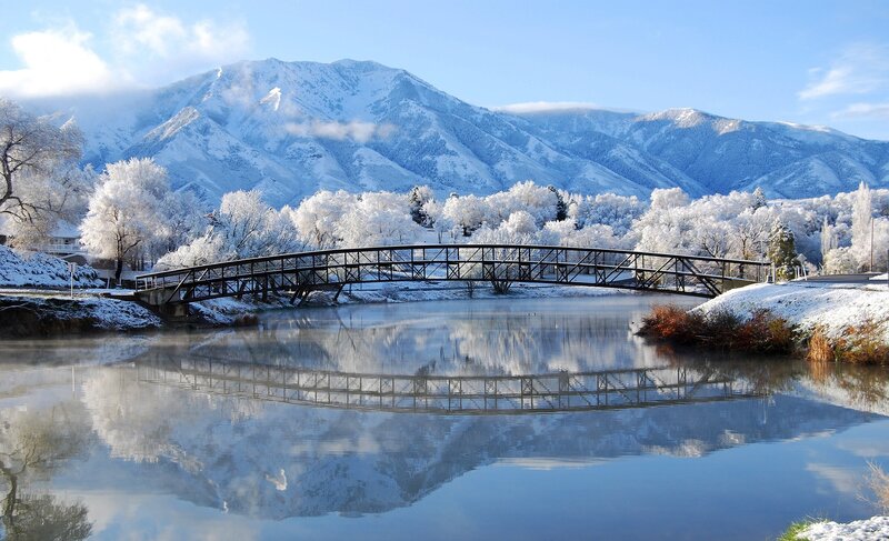 Snowy mountain bridge reflection