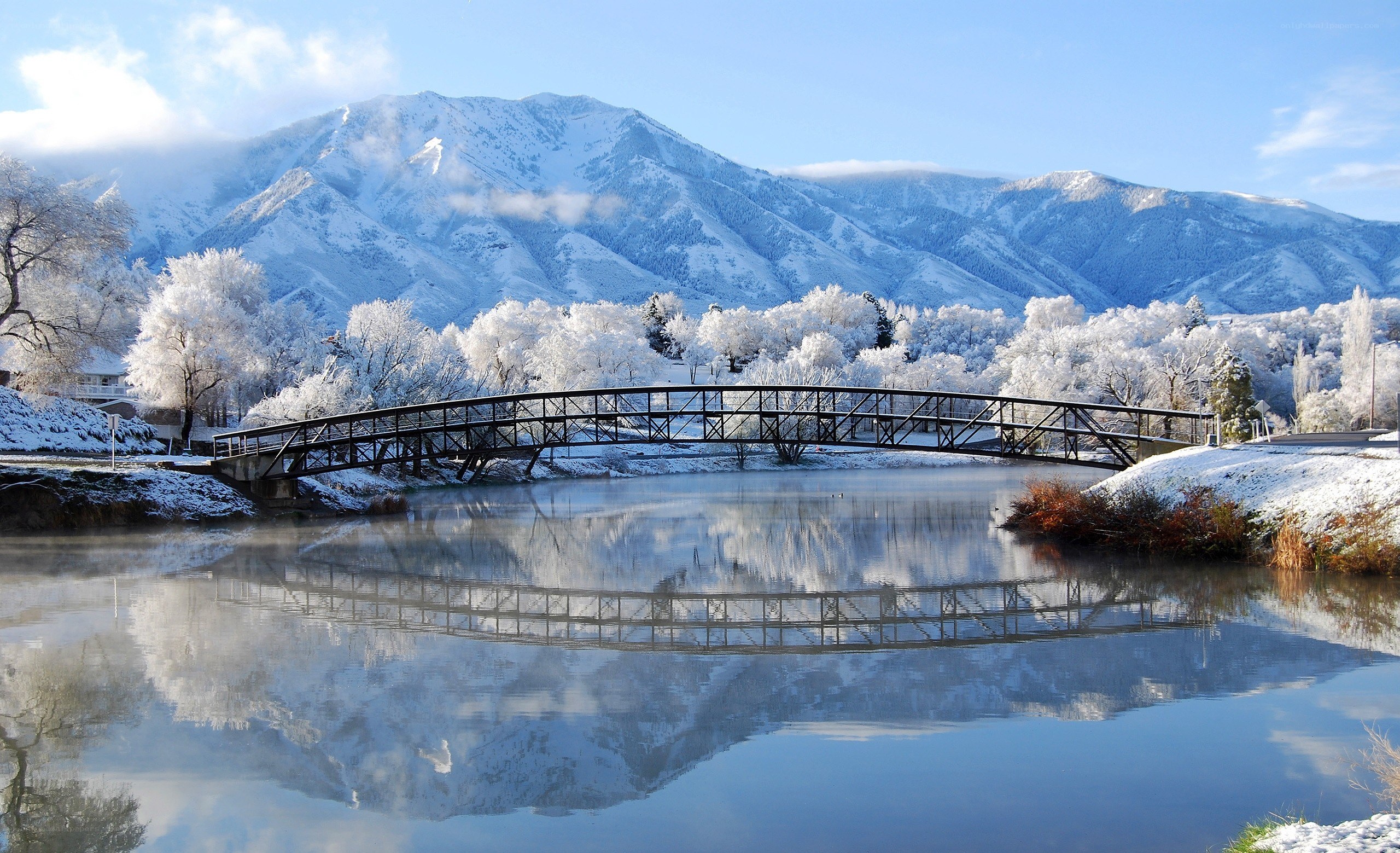 Snowy mountain bridge reflection