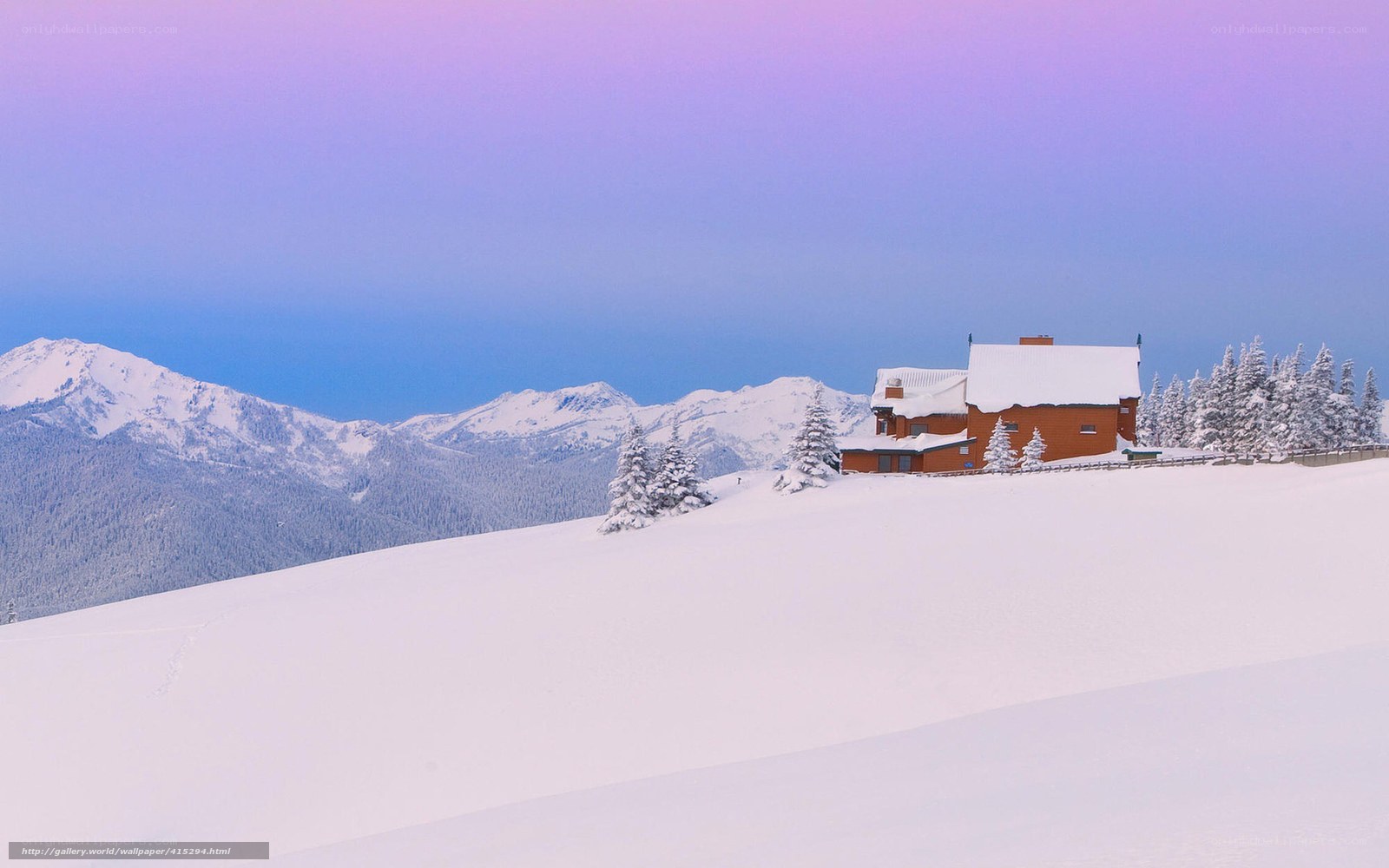 Snowy mountain cabin at dusk