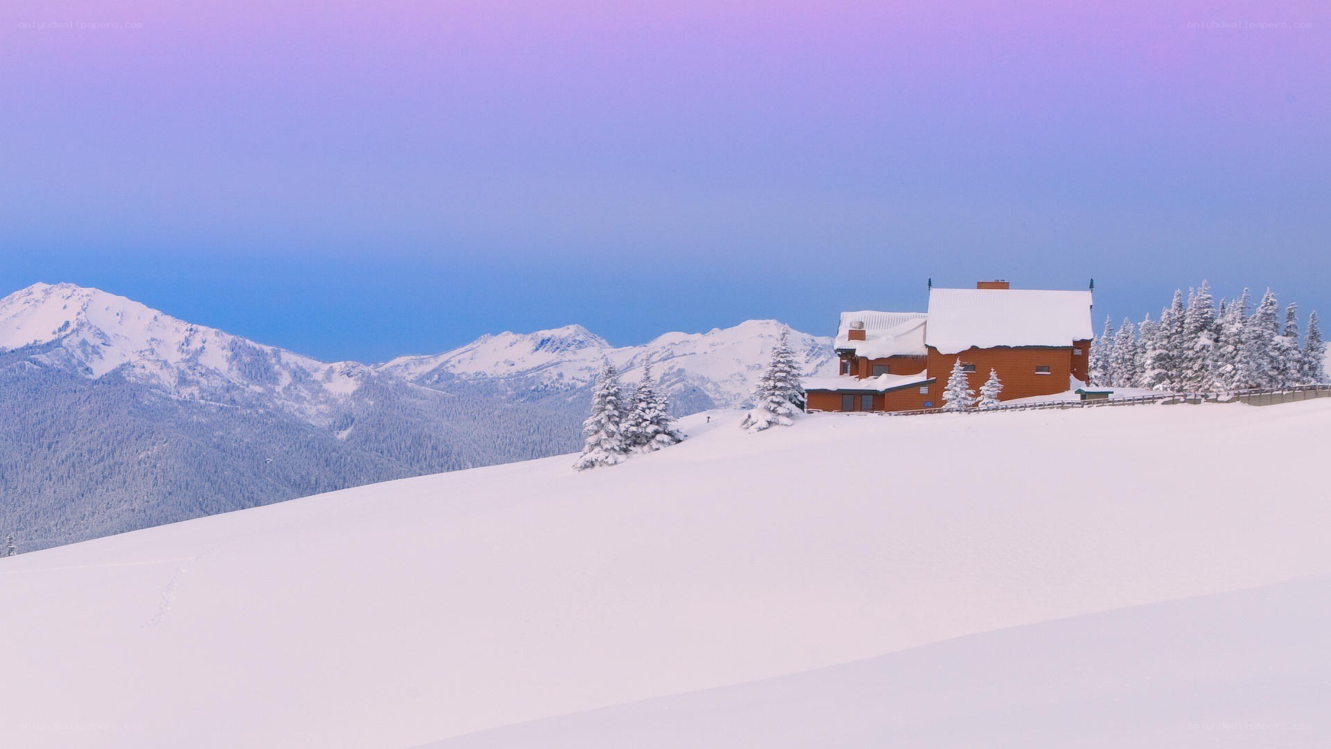 Snowy mountain cabin at dusk