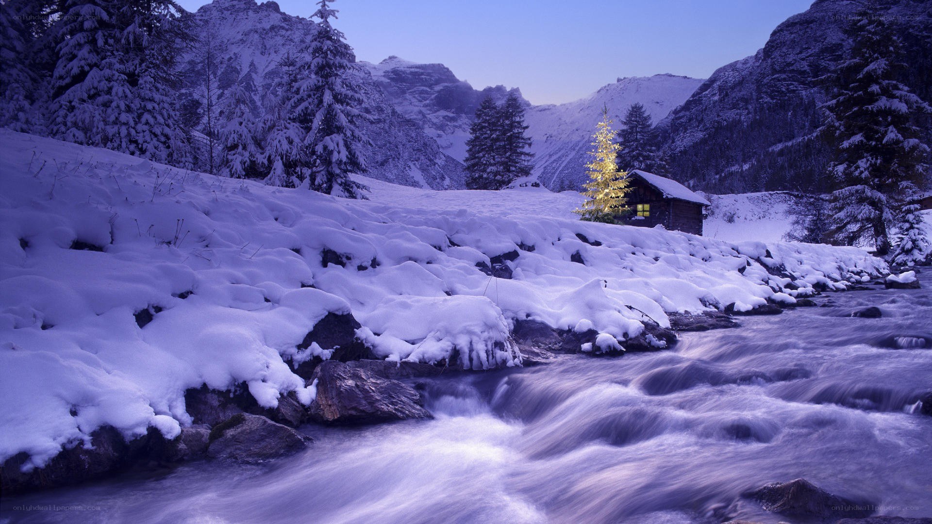 Snowy mountain cabin at dusk