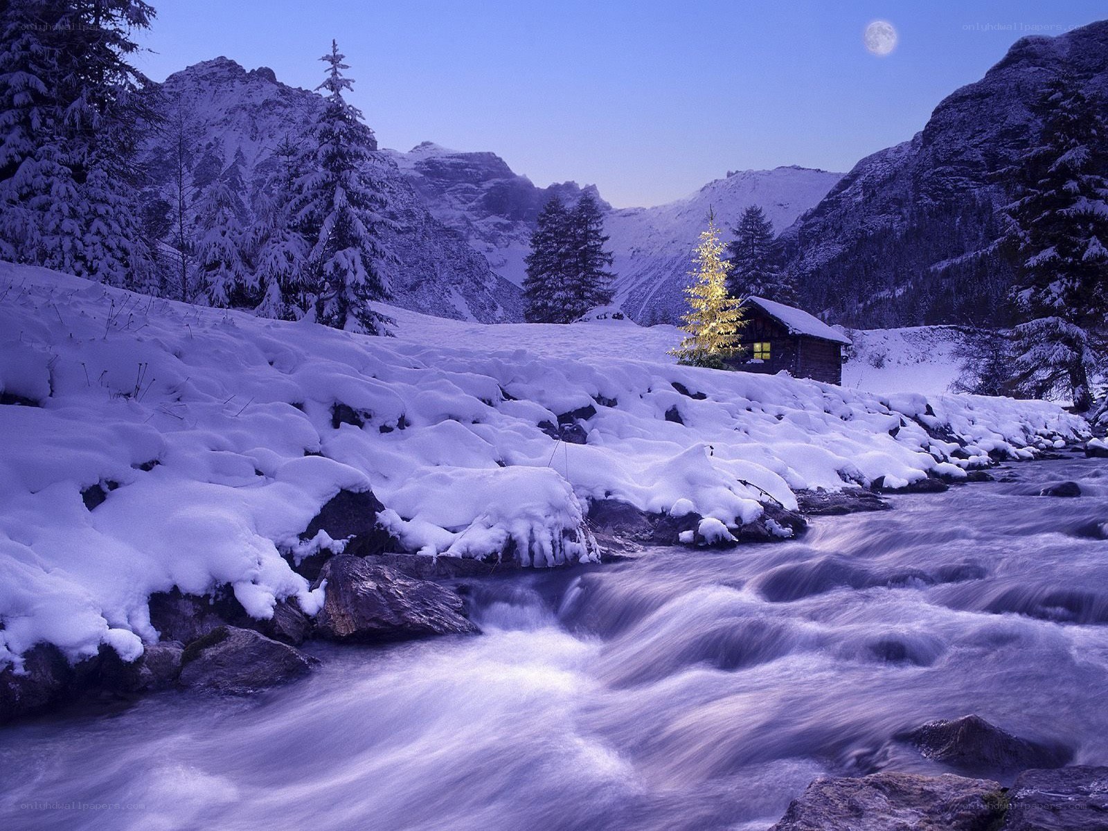 Snowy mountain cabin at night