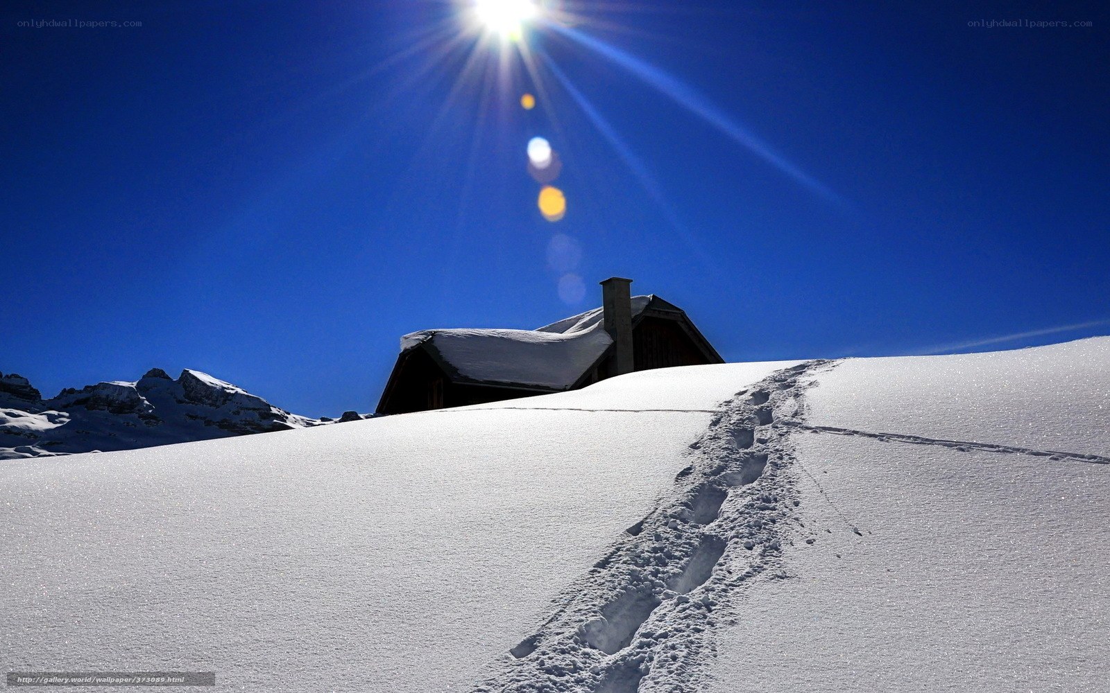 Snowy mountain cabin with footprints