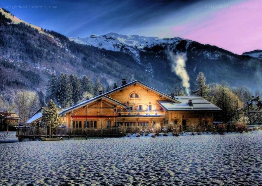 Snowy mountain chalet at dusk