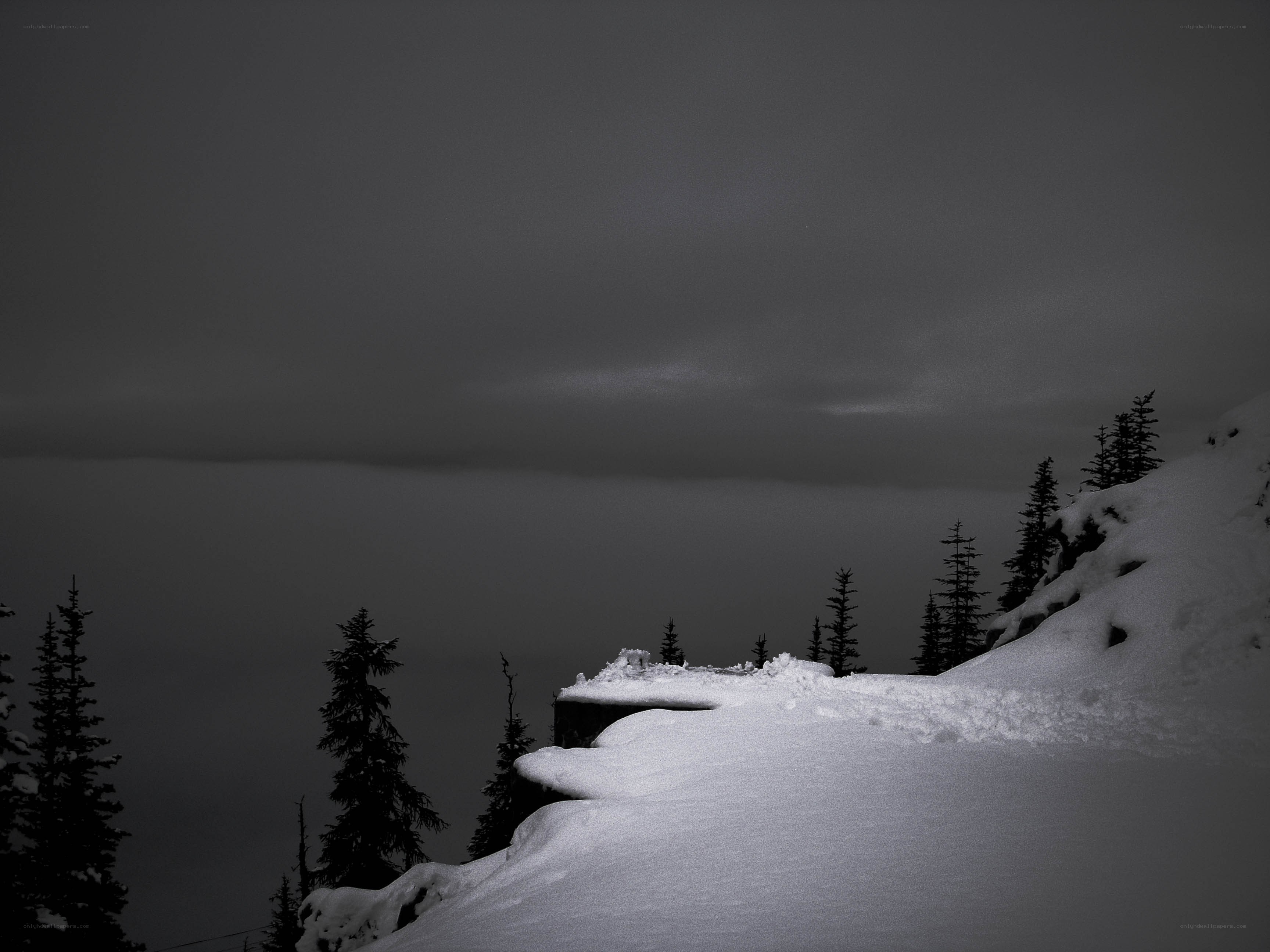 Snowy mountain cliff at dusk