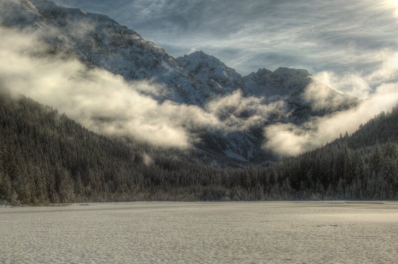 Snowy mountain lake at dawn
