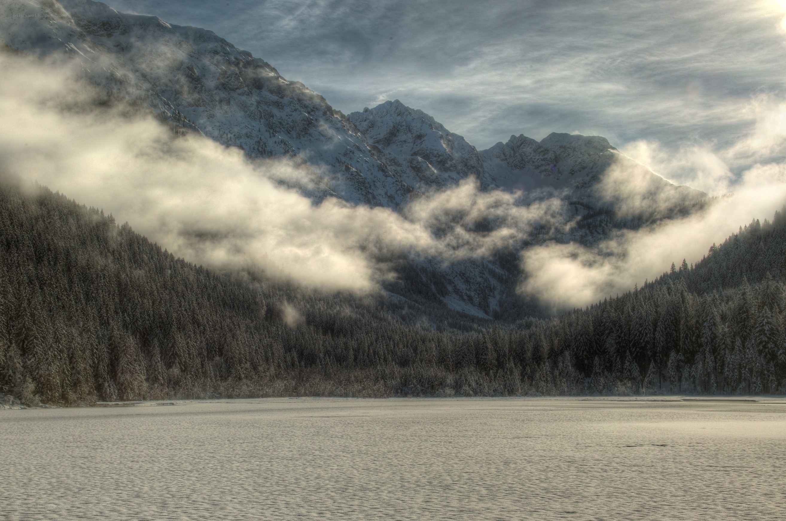 Snowy mountain lake at dawn