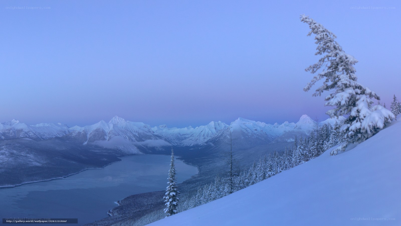 Snowy mountain lake at dawn