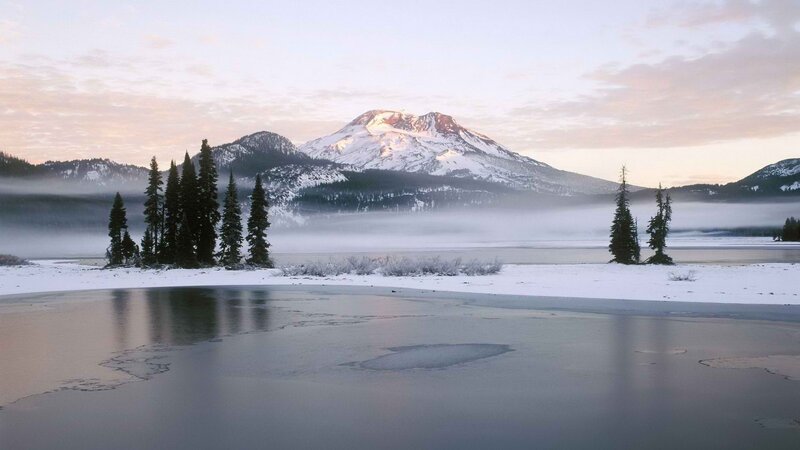 Snowy mountain lake at dawn