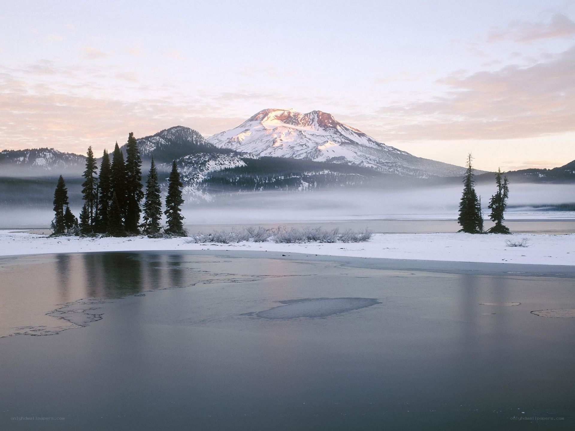 Snowy mountain lake at dawn