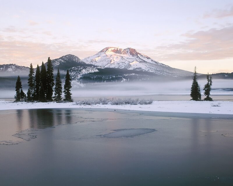 Snowy mountain lake at dawn