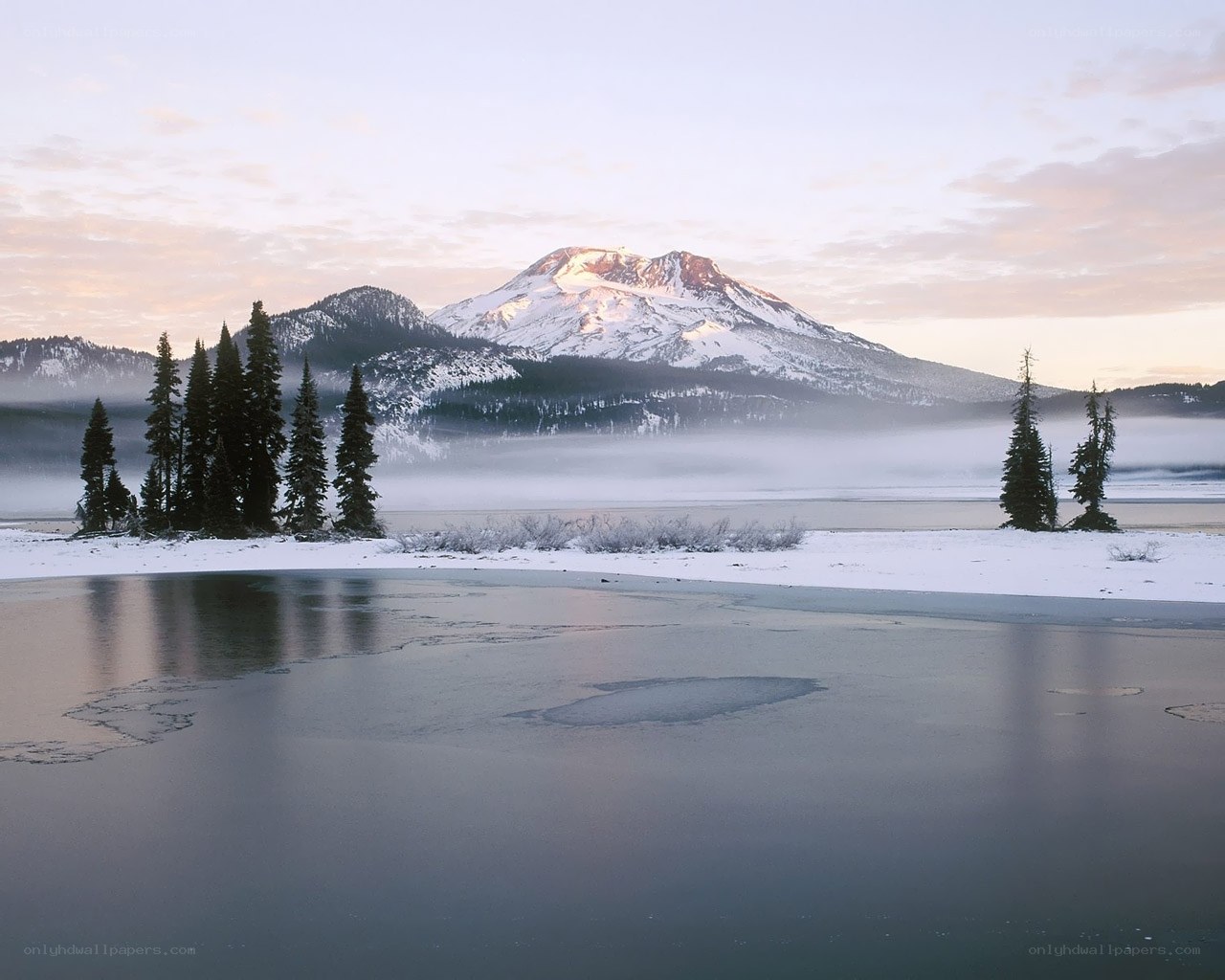 Snowy mountain lake at dawn