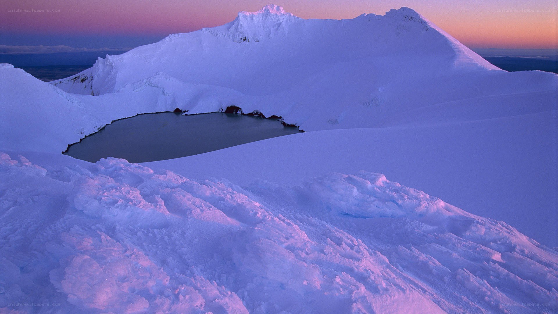 Snowy mountain lake at dusk