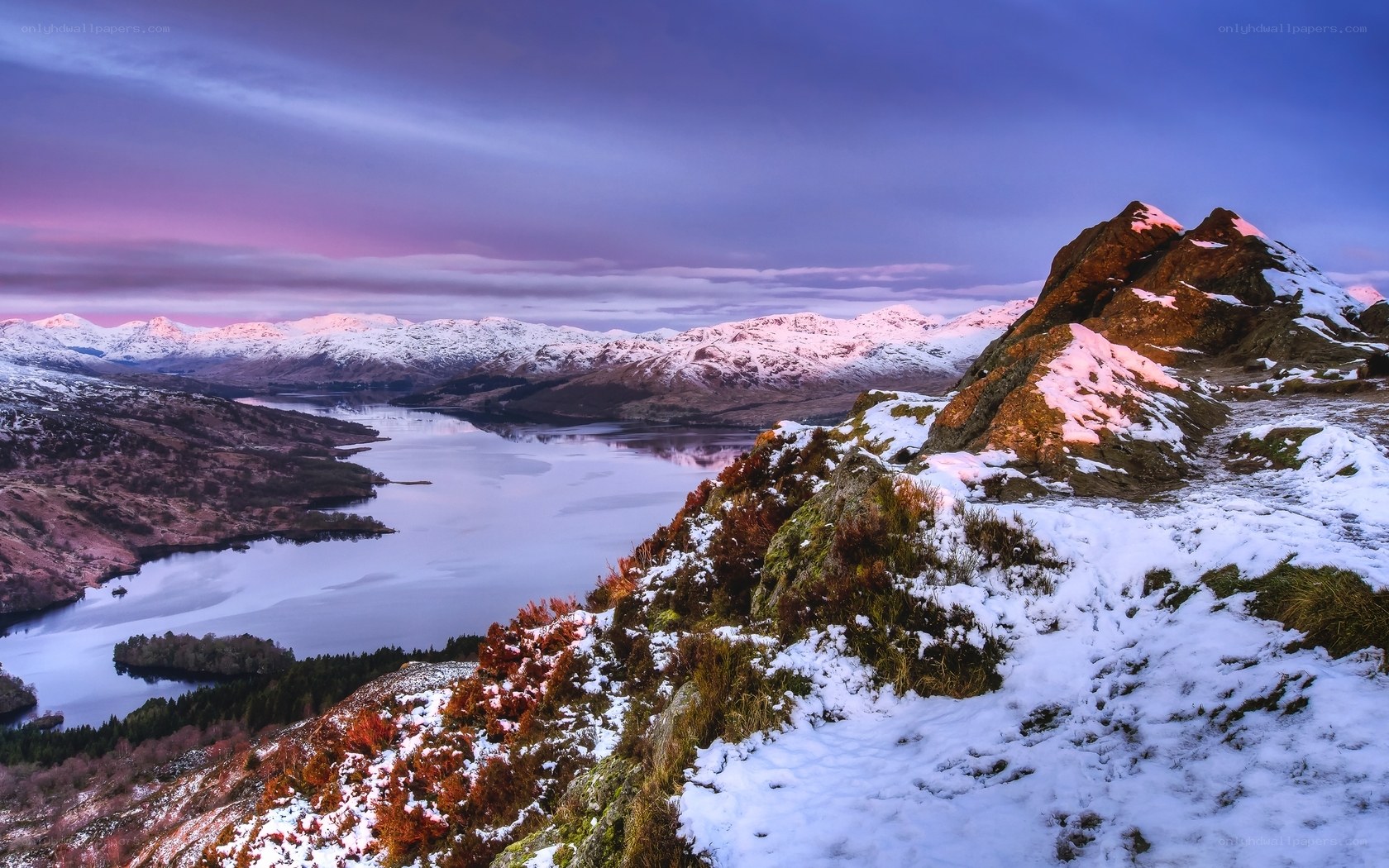 Snowy mountain lake at dusk