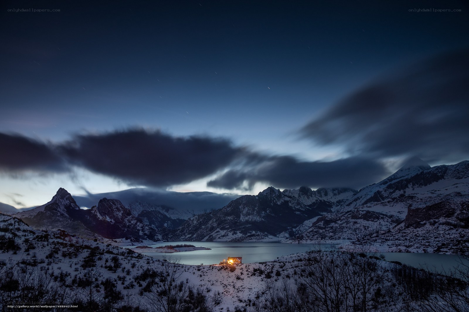 Snowy mountain lake at night