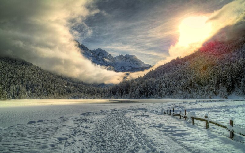 Snowy mountain lake at sunrise