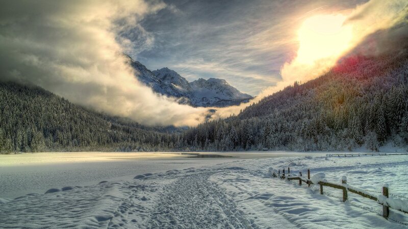 Snowy mountain lake at sunrise